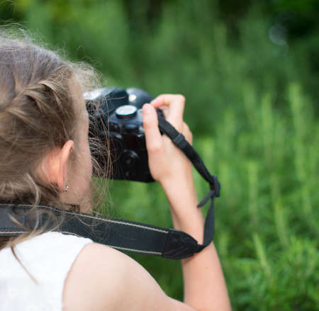 Cute little girl doing photographs of nature.の写真素材