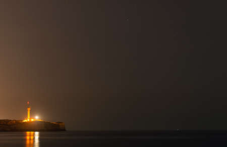 Lighthouse at night in Portimao, Portugal.の写真素材