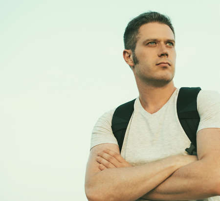 Handsome male tourist with backpack. Space for text.の写真素材