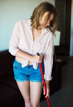 Pretty woman cleaning the floor with mop.の写真素材