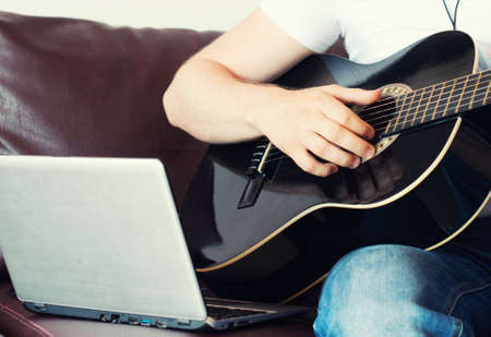 Man recording a song with guitar.の写真素材