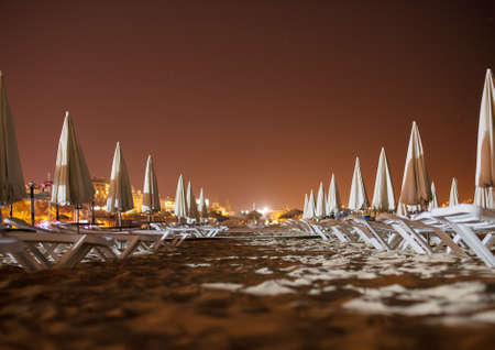 Sun loungers on the beach at night.の写真素材