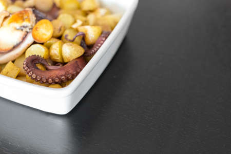 Baked Octopus with Potatoes. Space for text.の写真素材