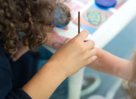 Artist drawing octopus on the child's hand.の写真素材