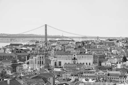Alfama downtown and the 25 April Bridge in Lisbon, Portugal.の写真素材