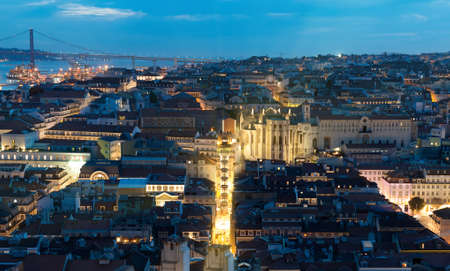 Alfama downtown and the 25 April Bridge in Lisbon at evening.の写真素材