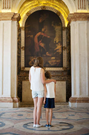 Mother and her daughter in the church.の写真素材