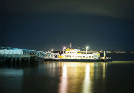 Moored ship at the pier at night.の写真素材