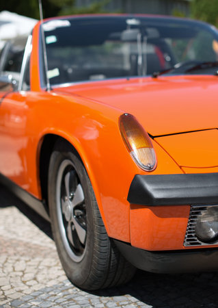Close-up view of orange retro car headlight.