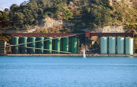 Industrial terminal with silos near the river.の写真素材