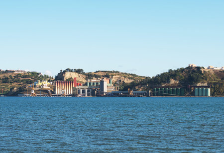 Industrial terminal with silos near the river.