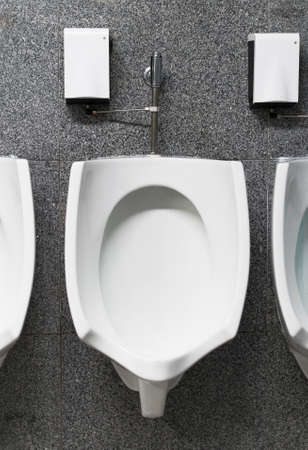 Urinal in public restroom.の写真素材