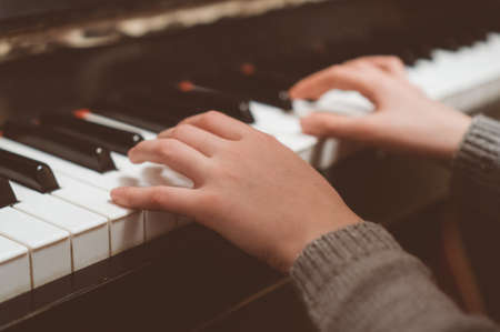 Child learns to play the piano.の写真素材