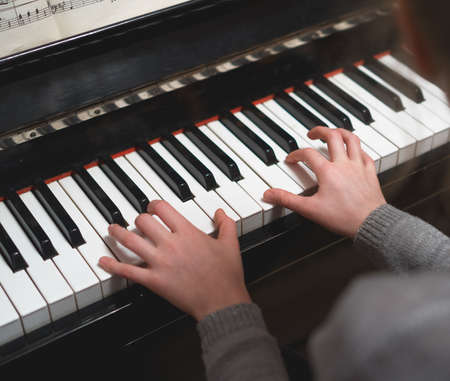 Child learns to play the piano.の写真素材