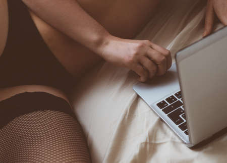 Woman working on as webcam model. Virtual sex.の写真素材
