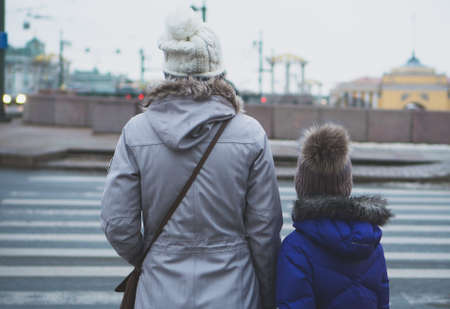 Mother and daughter crossing the road. Back view.の写真素材