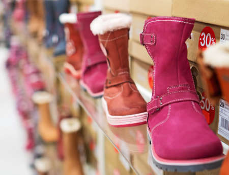 Collection of different winter kids shoes in shop.の写真素材