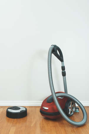 Robotic vacuum cleaner vs Vacuum cleaner.の写真素材
