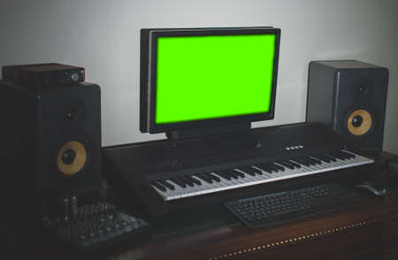 Home recording studio with professional monitors and midi keyboard. Green screen.の写真素材