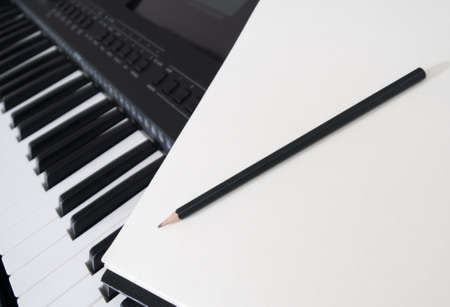 Piano keyboard, pen and sheet. Concept of composing song.の写真素材