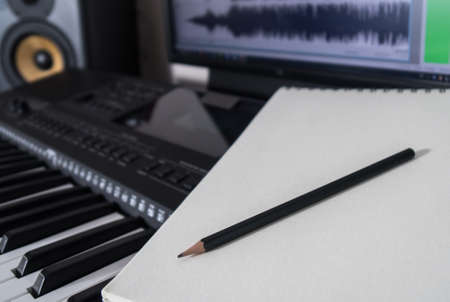 Piano keyboard, pen and sheet. Concept of composing song.の写真素材