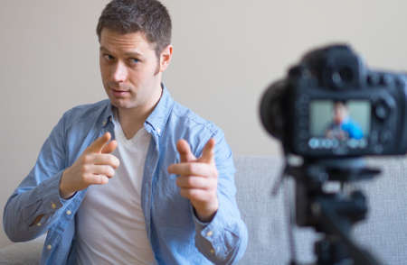 Handsome man making video blog. Concept of blogging.の写真素材