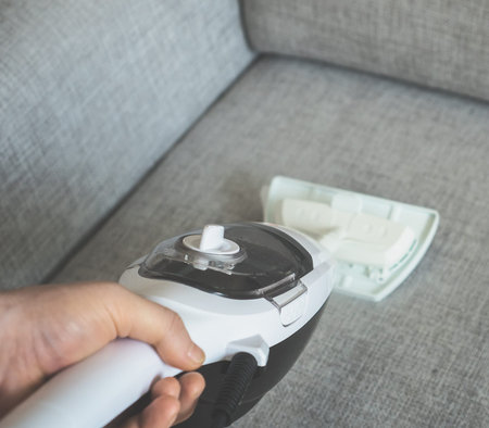 Cleaning fabric of the sofa with a steam cleaner.の写真素材