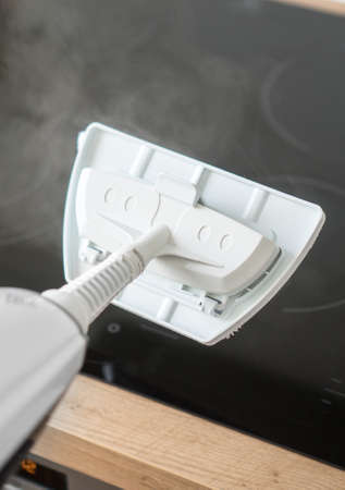 Cleaning kitchen hob with a steam cleaner.の写真素材