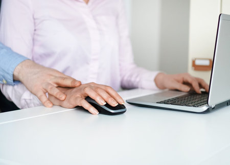 Sexual harassment at work. Man touching secretary's hand.