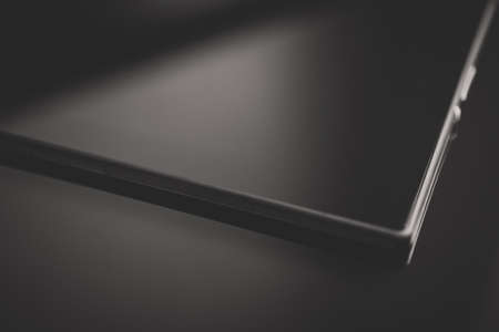 Black tablet pc on mirrored surface. Space for your text.の写真素材