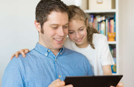 Father and his daughter using tablet pc.の写真素材