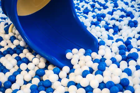 Lot of blue and white plastic balls in playroom.の写真素材