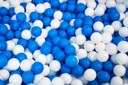 Lot of blue and white plastic balls in playroom.の写真素材