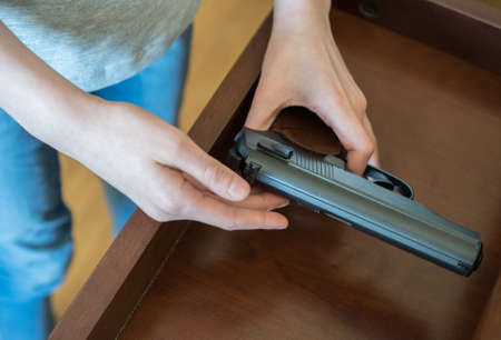 Child found pistol in drawer at home.の写真素材