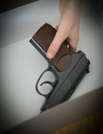 Child found pistol in box at home.