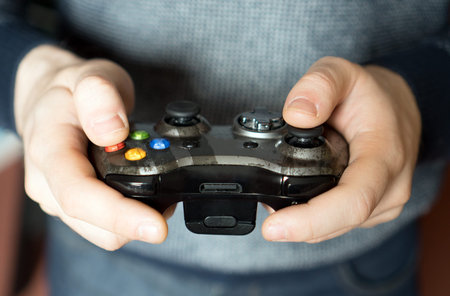 Man playing computer games with a joystick.