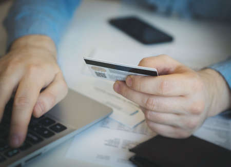 Man using credit card to pay in internet shop.の写真素材