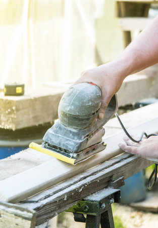 Handyman using polish machine outdoors.