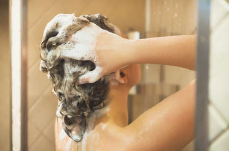 Woman washing her head in the shower.の写真素材