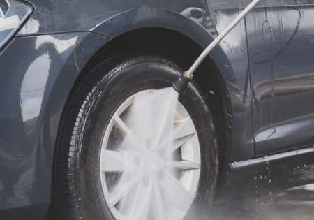 Car wash using high pressure water jet.の写真素材