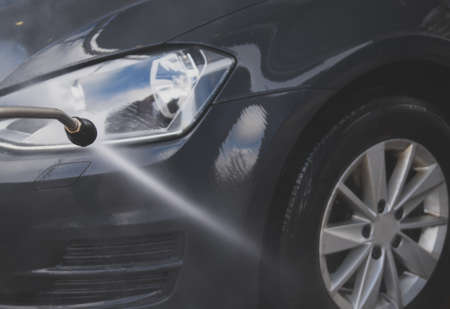 Car wash using high pressure water jet.の写真素材