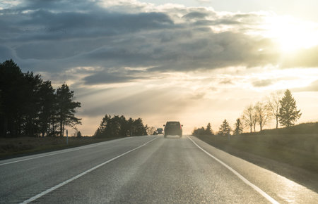 Cars going on the road after the rain.の写真素材