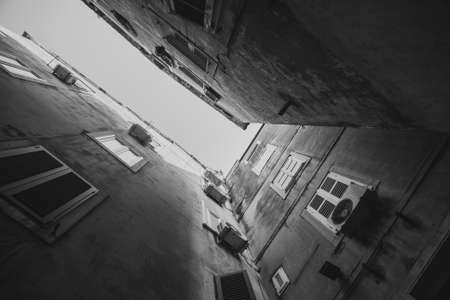 Building architecture in old town of Split. Rooftops with communications. Black and white.の写真素材