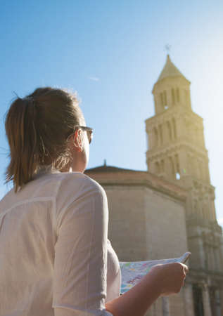 Female tourist with map visiting the city of Split.の写真素材