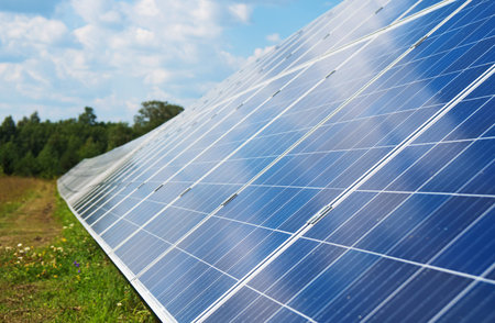 Blue solar panels in the field. Renewable energy.