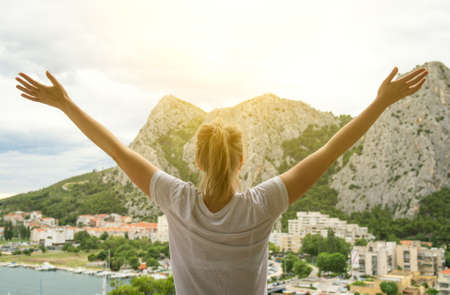 Woman with arms wide open enjoying views.の写真素材