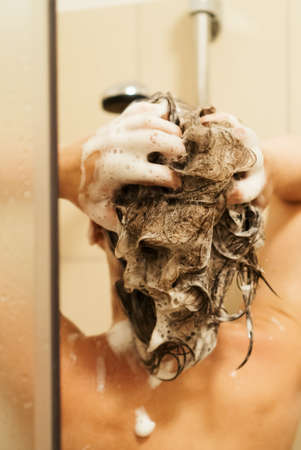 Woman washing her head in the shower.の写真素材