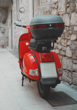 Red scooter parked on the empty street.のeditorial素材
