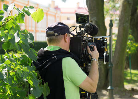 Journalist shooting with professional TV camera.の写真素材