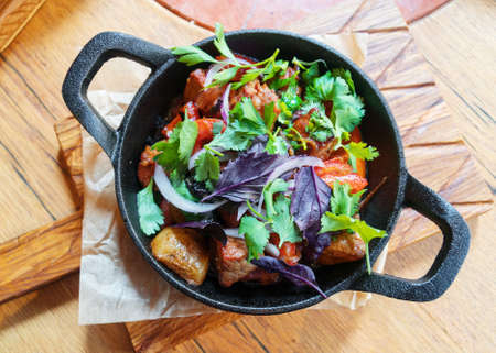 Fried meat with potatoes and vegetables.の写真素材
